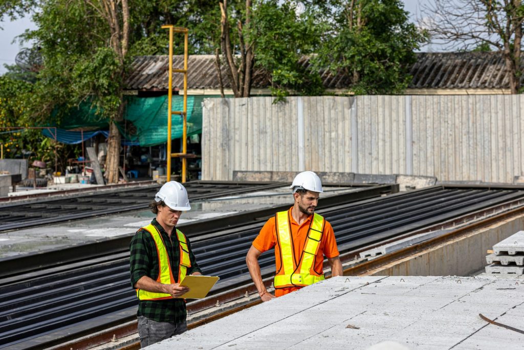 Construction workers review plans at a job site.