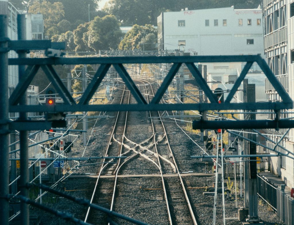 a view of a train track with buildings in the background